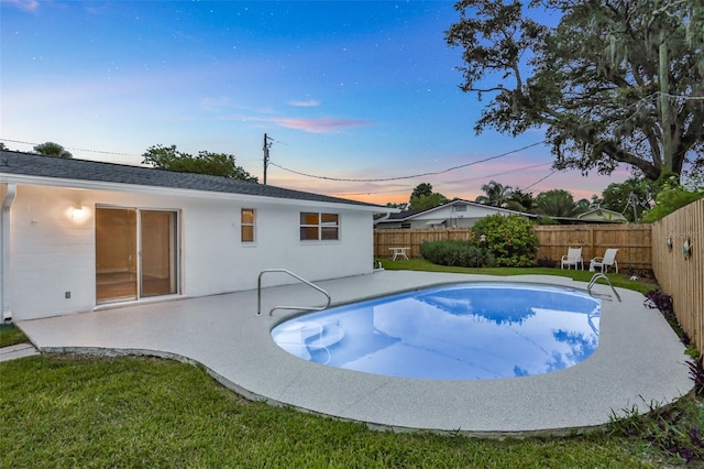 749 Ridge Blvd, South Daytona, FL 32119 - pool at dusk with a fenced backyard and a patio area