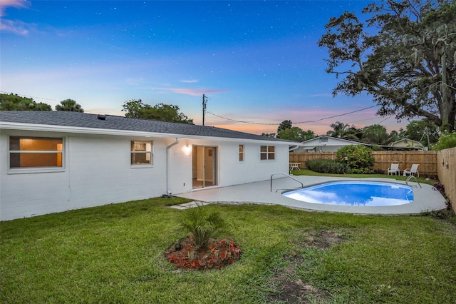 749 Ridge Blvd, South Daytona, FL 32119 - back of house at dusk featuring a fenced backyard and a patio