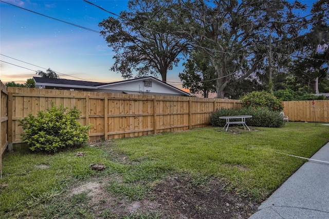 749 Ridge Blvd, South Daytona, FL 32119 - yard at dusk with a fenced backyard