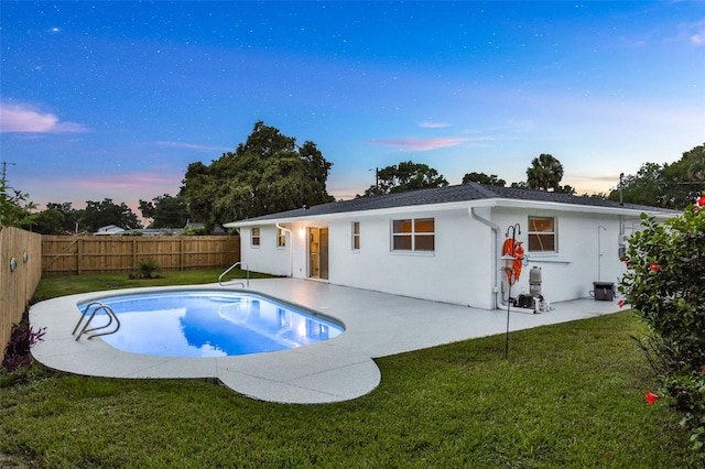 749 Ridge Blvd, South Daytona, FL 32119 - back of property at dusk featuring a fenced backyard, stucco siding, and a patio