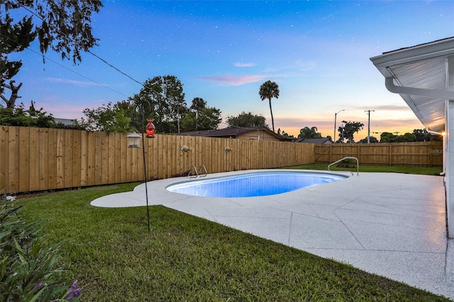 749 Ridge Blvd, South Daytona, FL 32119 - pool at dusk with a fenced backyard and a patio