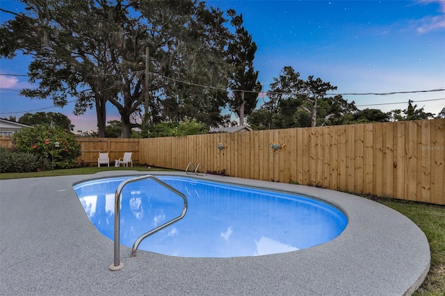 749 Ridge Blvd, South Daytona, FL 32119 - pool at dusk with a fenced backyard