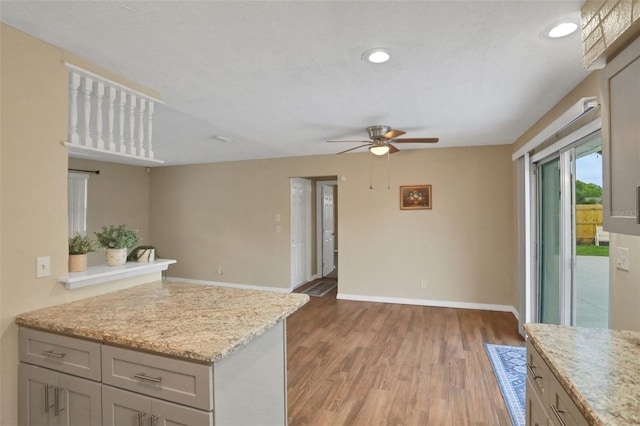 749 Ridge Blvd, South Daytona, FL 32119 - kitchen with ceiling fan, recessed lighting, light wood finished floors, gray cabinetry, and light stone counters