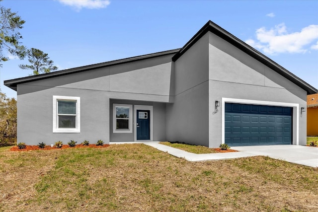 13673 SW 43th Cir, Ocala, FL 34473 - view of front facade featuring driveway, a front lawn, a garage, and stucco siding
