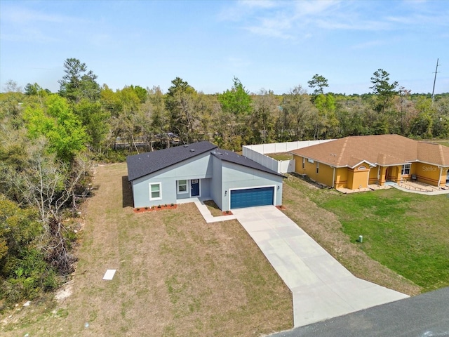 13673 SW 43th Cir, Ocala, FL 34473 - view of front facade with an attached garage, concrete driveway, a front yard, and stucco siding