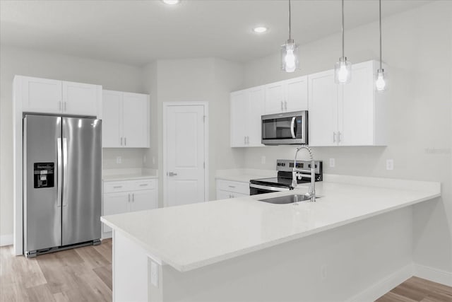 13673 SW 43th Cir, Ocala, FL 34473 - kitchen with appliances with stainless steel finishes, light wood-style flooring, light countertops, white cabinetry, and recessed lighting