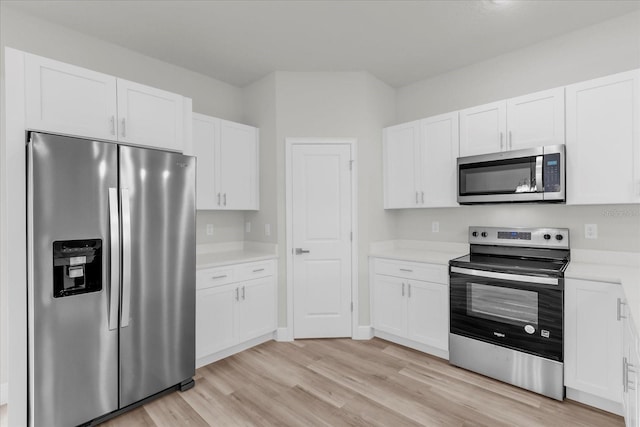 13673 SW 43th Cir, Ocala, FL 34473 - kitchen featuring appliances with stainless steel finishes, light countertops, white cabinetry, and light wood-style floors