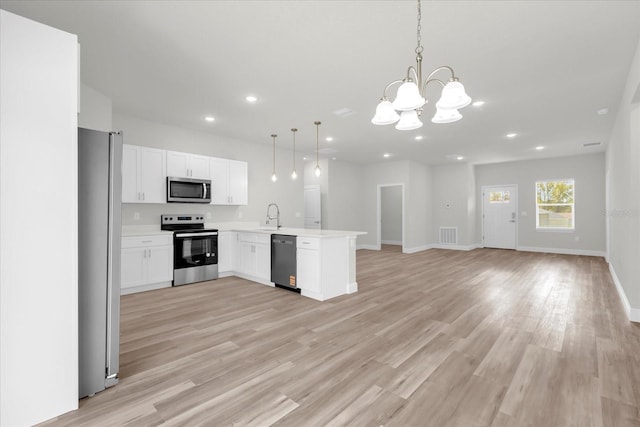 13673 SW 43th Cir, Ocala, FL 34473 - kitchen featuring appliances with stainless steel finishes, open floor plan, a chandelier, recessed lighting, and a peninsula