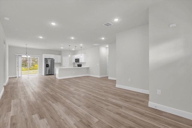 13673 SW 43th Cir, Ocala, FL 34473 - unfurnished living room featuring recessed lighting and light wood-style floors