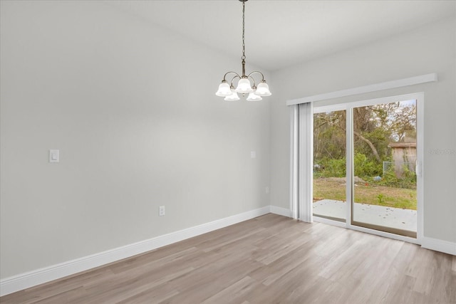 13673 SW 43th Cir, Ocala, FL 34473 - spare room with a chandelier and light wood-style floors