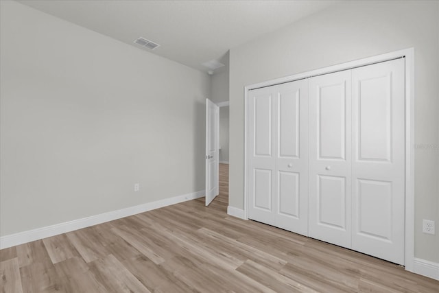 13673 SW 43th Cir, Ocala, FL 34473 - unfurnished bedroom featuring light wood-style flooring and a closet