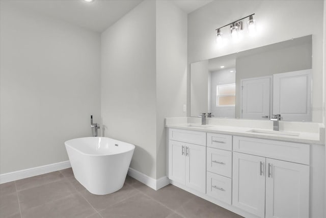13673 SW 43th Cir, Ocala, FL 34473 - bathroom with double vanity, a soaking tub, and tile patterned floors