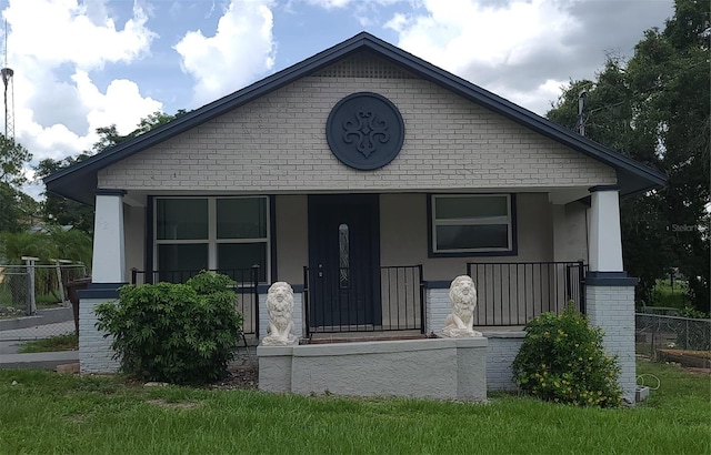 421 N 2nd St, Haines City, FL 33844 - bungalow with a porch, brick siding, and stucco siding