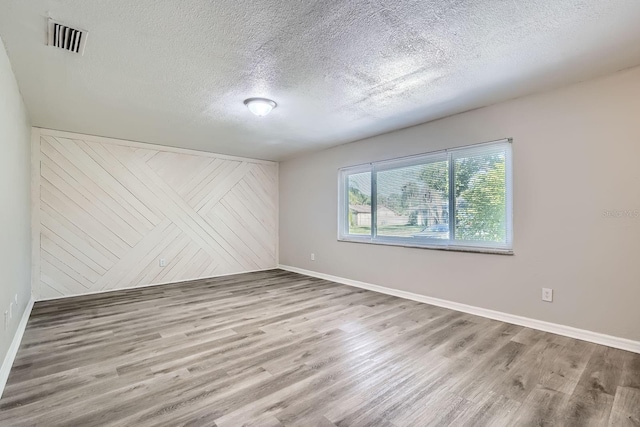 1175 Tracy Dr, Port Orange, FL 32129 - unfurnished room featuring wood finished floors and a textured ceiling