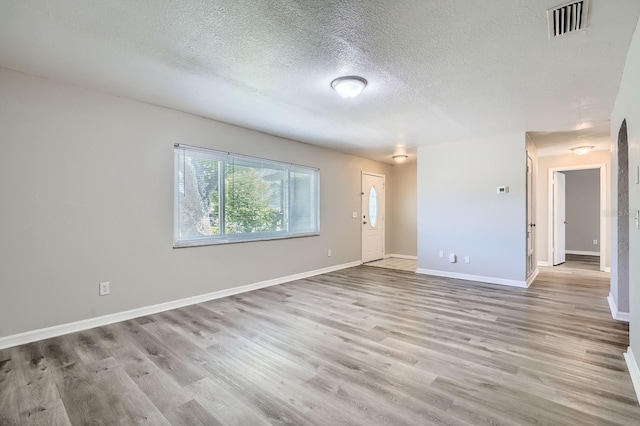 1175 Tracy Dr, Port Orange, FL 32129 - unfurnished room with a textured ceiling and wood finished floors