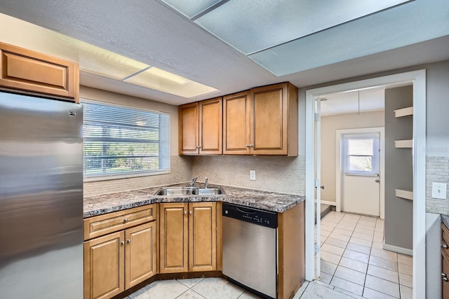 1175 Tracy Dr, Port Orange, FL 32129 - kitchen with stainless steel appliances, light tile patterned floors, tasteful backsplash, and brown cabinetry