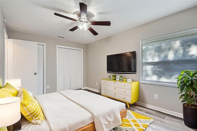 1175 Tracy Dr, Port Orange, FL 32129 - bedroom featuring multiple closets, light wood-style floors, and ceiling fan