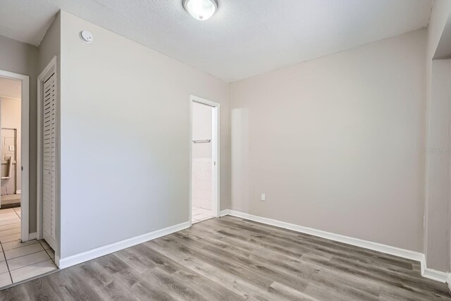 1175 Tracy Dr, Port Orange, FL 32129 - unfurnished bedroom featuring light wood finished floors and connected bathroom