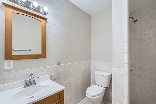 1175 Tracy Dr, Port Orange, FL 32129 - full bathroom featuring tile walls, vanity, tiled shower, and wainscoting