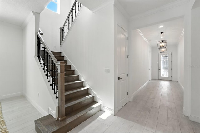 15315 Gilligan Ct, Winter Garden, FL 34787 - foyer with plenty of natural light, crown molding, a chandelier, stairway, and wood finished floors