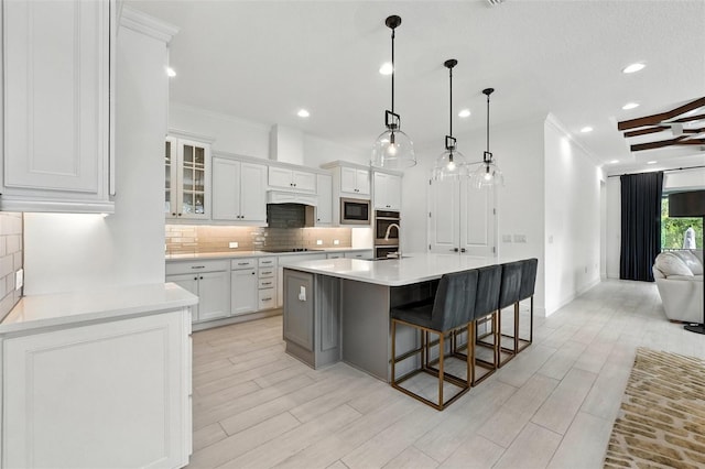 15315 Gilligan Ct, Winter Garden, FL 34787 - kitchen with ornamental molding, tasteful backsplash, recessed lighting, white cabinets, and light countertops