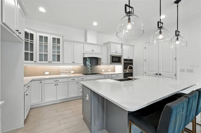 15315 Gilligan Ct, Winter Garden, FL 34787 - kitchen with stainless steel double oven, built in microwave, ornamental molding, white cabinets, and tasteful backsplash