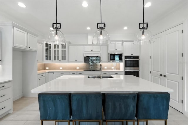 15315 Gilligan Ct, Winter Garden, FL 34787 - kitchen with stainless steel appliances, white cabinetry, decorative backsplash, and recessed lighting