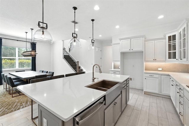 15315 Gilligan Ct, Winter Garden, FL 34787 - kitchen featuring dishwasher, wood tiled floors, light countertops, an island with sink, and recessed lighting