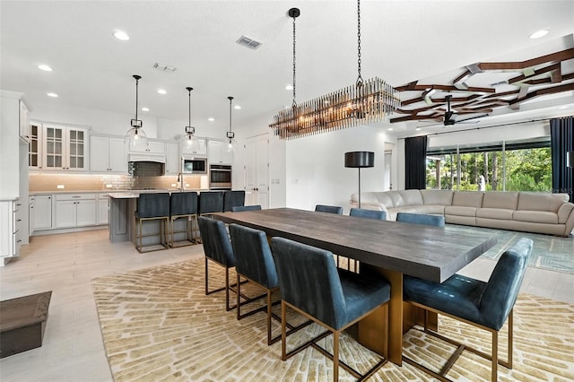 15315 Gilligan Ct, Winter Garden, FL 34787 - dining space with recessed lighting, a chandelier, a ceiling fan, and light wood finished floors