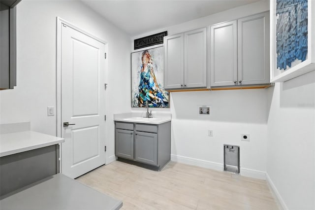 15315 Gilligan Ct, Winter Garden, FL 34787 - laundry room with cabinet space, electric dryer hookup, hookup for a washing machine, and light wood finished floors