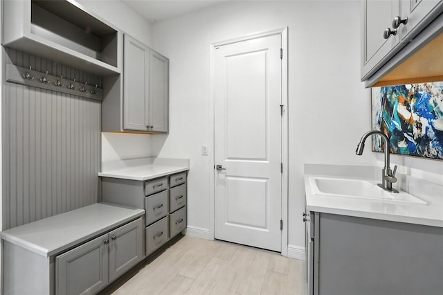 15315 Gilligan Ct, Winter Garden, FL 34787 - laundry area with a sink and light wood-style flooring