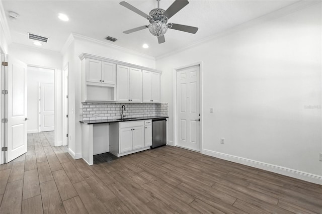 15315 Gilligan Ct, Winter Garden, FL 34787 - kitchen featuring stainless steel dishwasher, a ceiling fan, dark countertops, decorative backsplash, and dark wood-type flooring