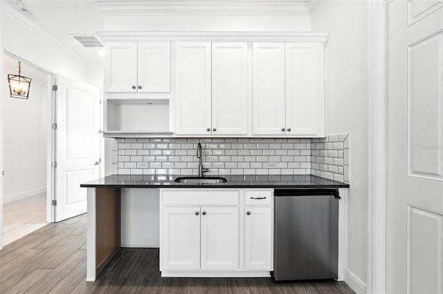 15315 Gilligan Ct, Winter Garden, FL 34787 - kitchen with dark countertops, ornamental molding, white cabinets, tasteful backsplash, and dark wood-type flooring