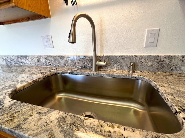 kitchen view of stone countertops and brown cabinetry