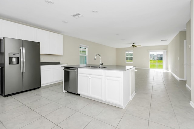 4288 Blackshear Ct, Clermont, FL 34714 - kitchen featuring stainless steel appliances, light tile patterned floors, ceiling fan, an island with sink, and white cabinets