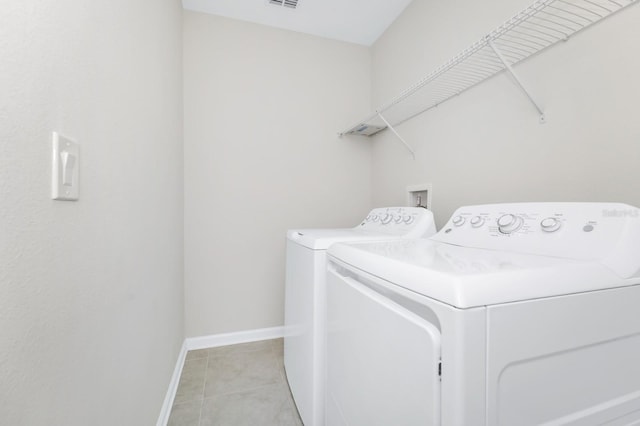4288 Blackshear Ct, Clermont, FL 34714 - laundry room with washer and clothes dryer and light tile patterned flooring