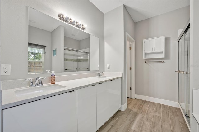 4636 Piedmont St, Orlando, FL 32811 - bathroom with a shower stall, double vanity, and wood finished floors