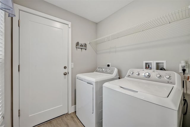 4636 Piedmont St, Orlando, FL 32811 - washroom featuring separate washer and dryer and light wood-style floors