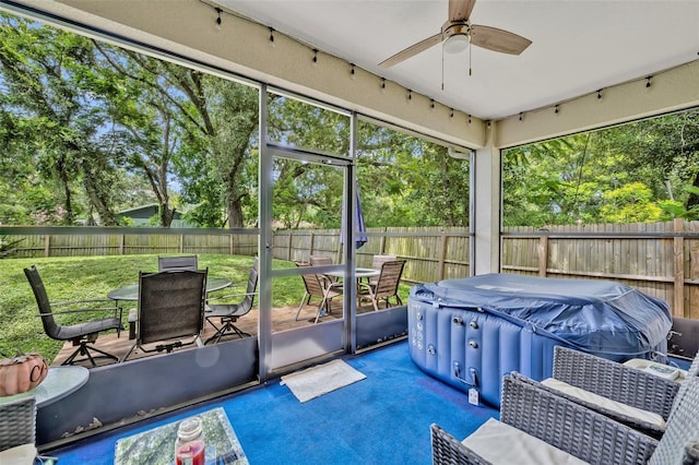 4636 Piedmont St, Orlando, FL 32811 - sunroom featuring outdoor dining area, a ceiling fan, a hot tub, and view of wooded area