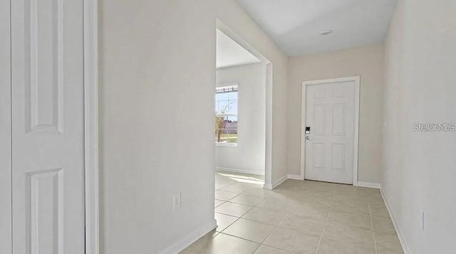 16480 Fernridge St, Clermont, FL 34714 - corridor with light tile patterned floors and baseboards