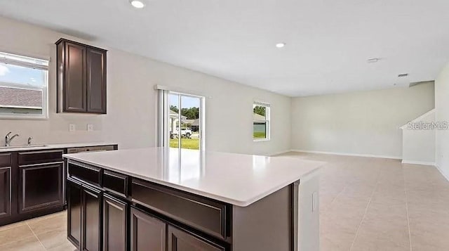 16480 Fernridge St, Clermont, FL 34714 - kitchen featuring light countertops, light tile patterned flooring, a kitchen island, open floor plan, and recessed lighting
