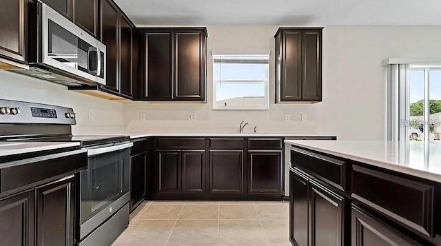 16480 Fernridge St, Clermont, FL 34714 - kitchen featuring stainless steel appliances, light tile patterned flooring, and light countertops