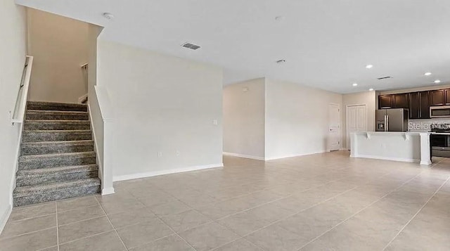 16480 Fernridge St, Clermont, FL 34714 - unfurnished living room featuring light tile patterned floors, recessed lighting, and stairs