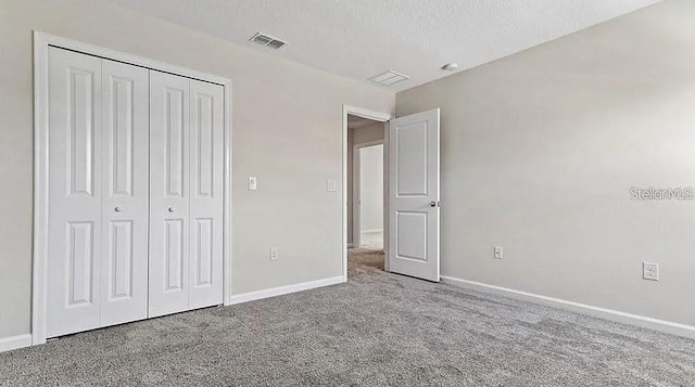 16480 Fernridge St, Clermont, FL 34714 - unfurnished bedroom featuring carpet, a textured ceiling, and a closet