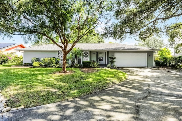 7201 Pleasant Dr, Orlando, FL 32818 - single story home with driveway, a garage, stucco siding, and a front yard