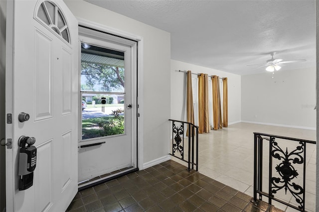 7201 Pleasant Dr, Orlando, FL 32818 - entrance foyer featuring a textured ceiling, a ceiling fan, and dark tile patterned flooring