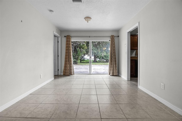 7201 Pleasant Dr, Orlando, FL 32818 - spare room featuring a textured ceiling, tile patterned floors, and a smoke detector