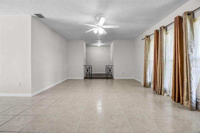 7201 Pleasant Dr, Orlando, FL 32818 - spare room with a textured ceiling, light tile patterned floors, and a ceiling fan
