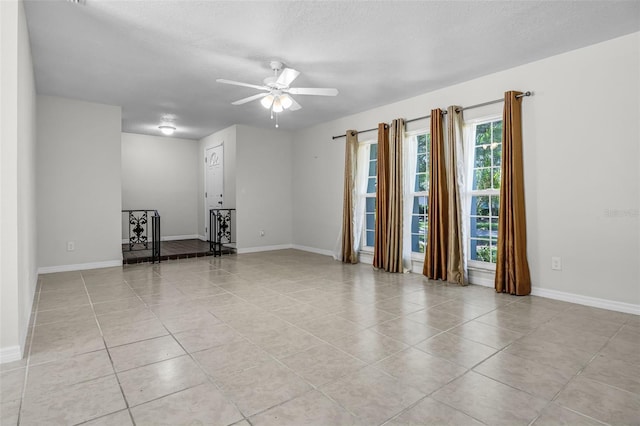 7201 Pleasant Dr, Orlando, FL 32818 - empty room featuring ceiling fan, light tile patterned floors, and a textured ceiling