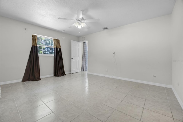 7201 Pleasant Dr, Orlando, FL 32818 - empty room with light tile patterned floors, ceiling fan, and a textured ceiling